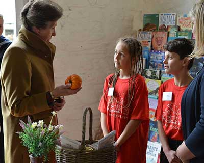 HRH the Princess Royal talking to children at Farms for City Children's Lower Treginnis farm.