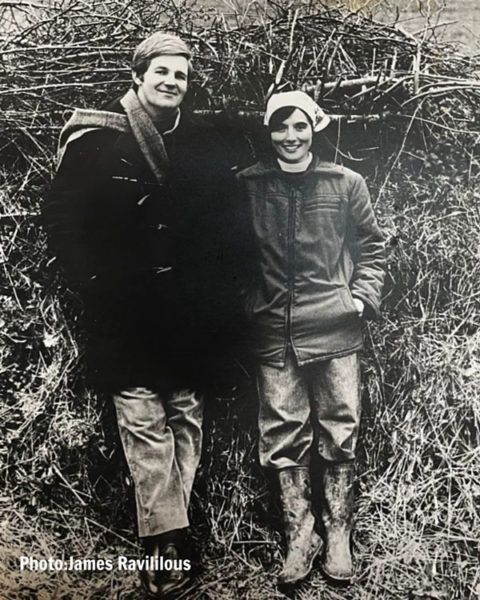 Clare and Michael Morpurgo standing on front of a hedgerow on the farm in 1976