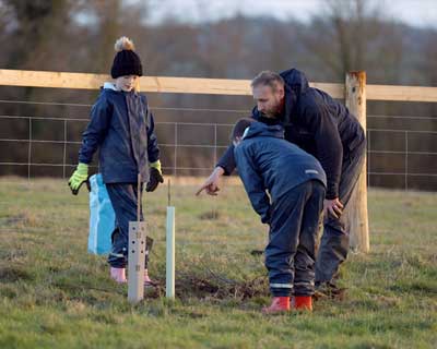 Children planting young trees in a Farms for City Children agroforestry project.