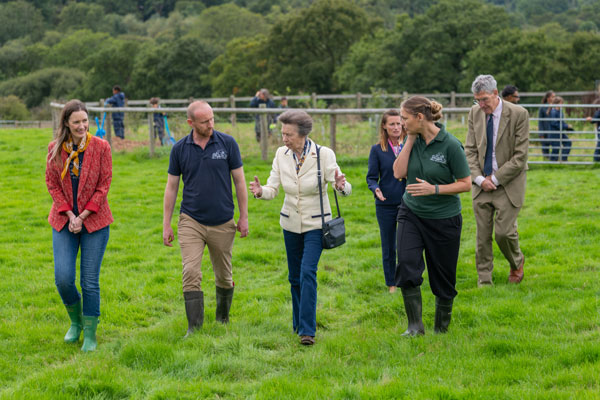 HRH The Princess Royal walking away from an agroforestry roundel with Farms for City Children staff.