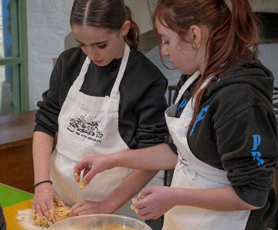 Two students mixing dough